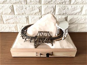 Micro layout baseboard with small wooden truss bridge and rock-shed
